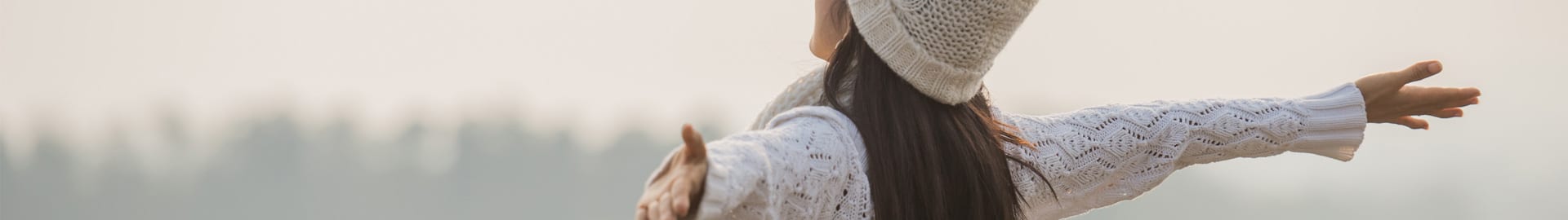 Woman spreading her arms in nature