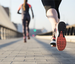 Image of two people running